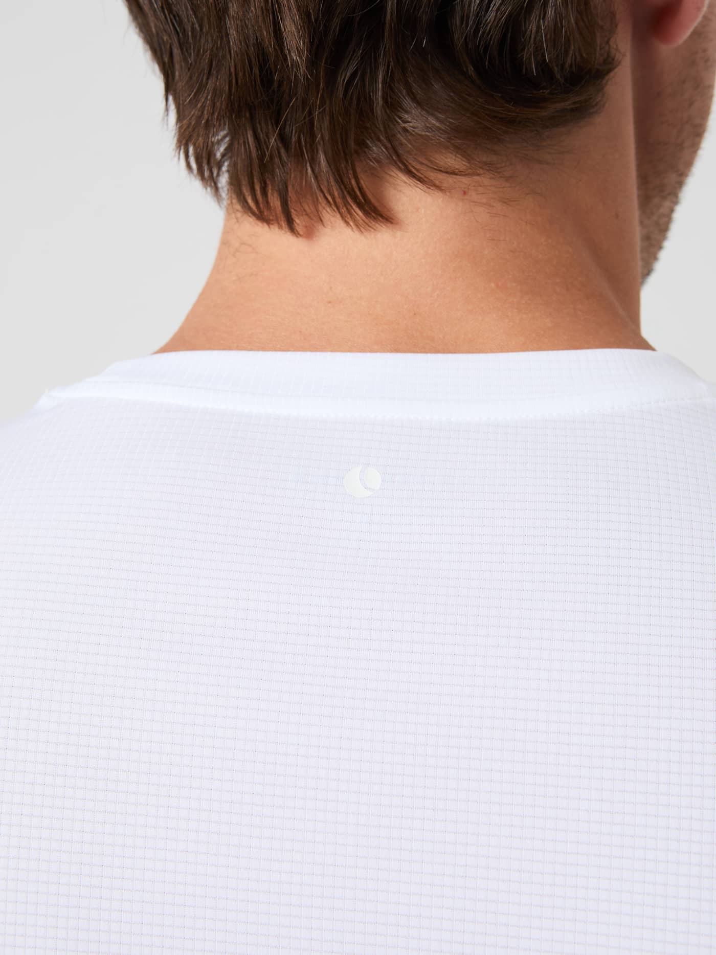 Close-up of the Borg Light T-Shirt in Brilliant White (White) with a tennis ball graphic on structured jersey fabric. - Image 4