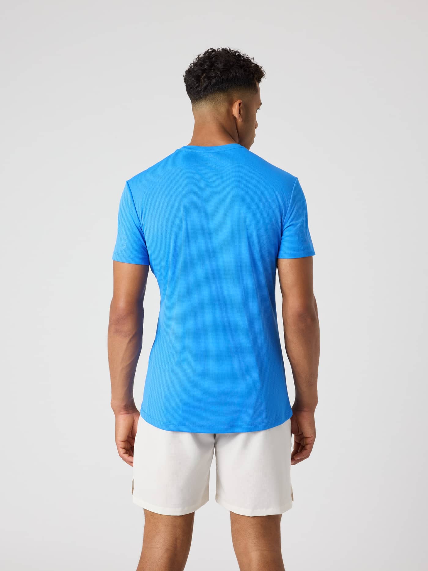 Back view of a man wearing the Björn Borg Light T-Shirt in Palace Blue (Blue) for functional training. - Image 2