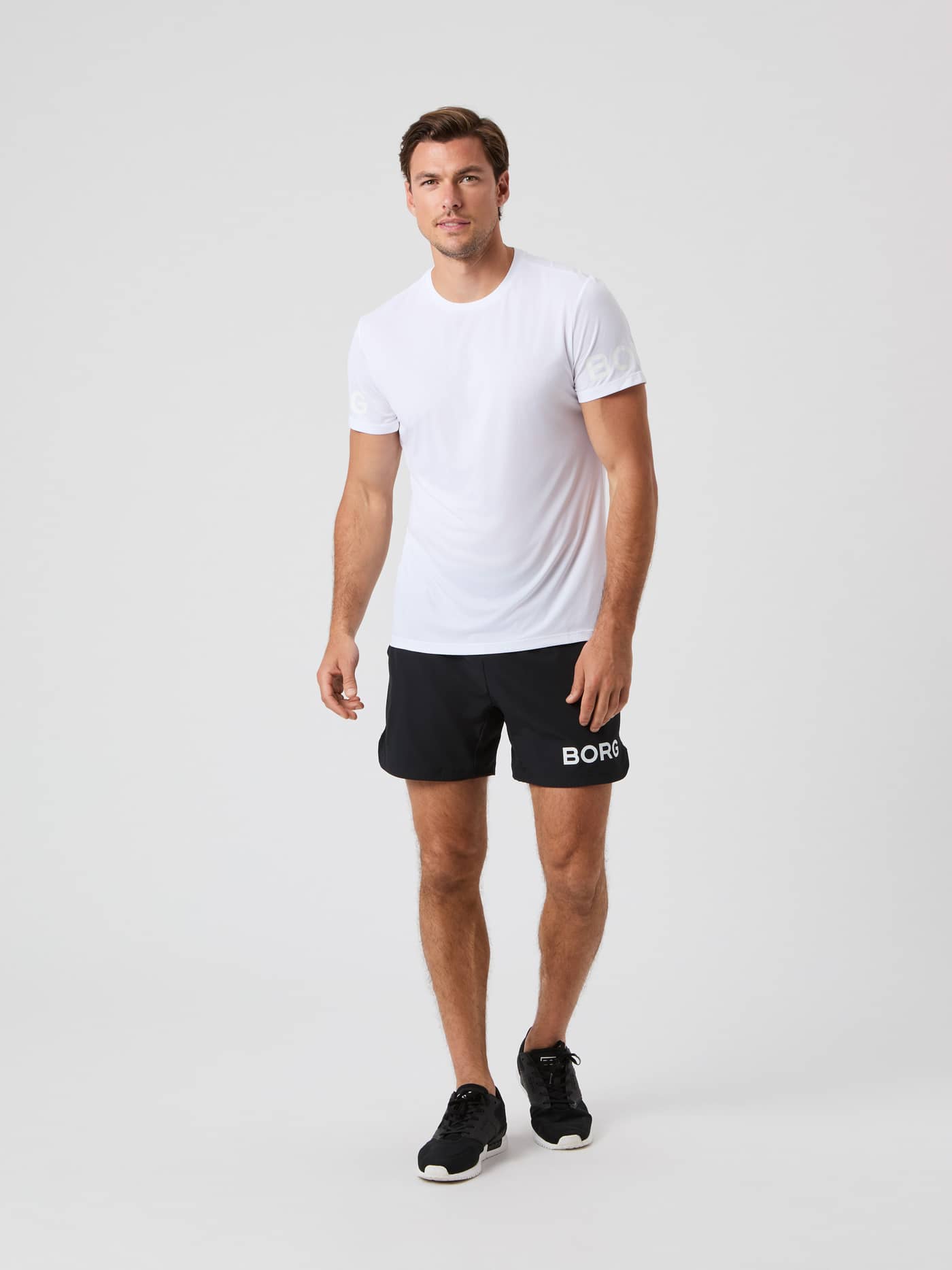 Full-body front view of a man in the Brilliant White (White) Borg Light T-Shirt, designed for training and tennis. - Image 3