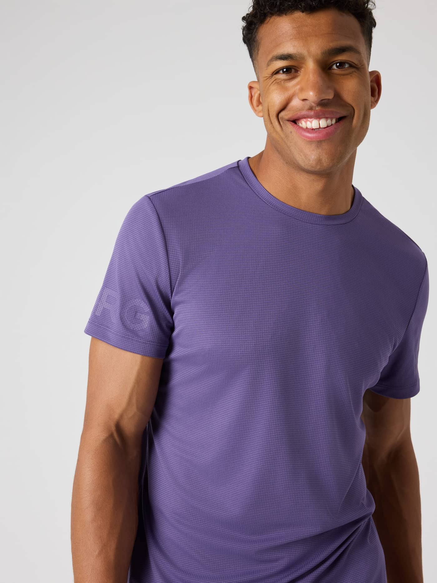 Front view of a man wearing the Mystical (purple) Borg Light T-Shirt, a training top in structured fabric with a purple logo. - Image 5