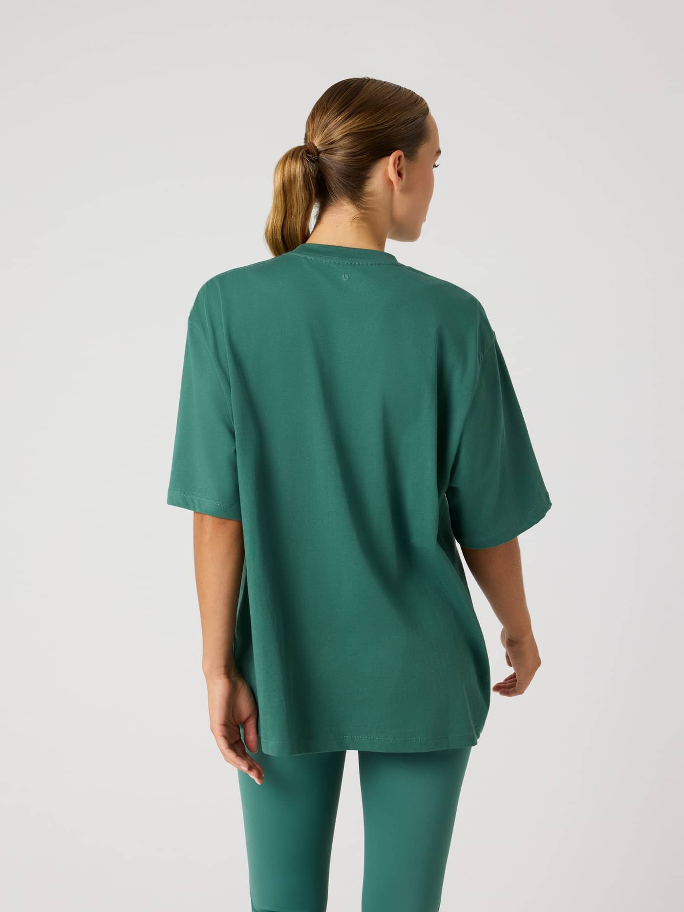 Back view of the Studio Oversized T-Shirt in Mallard Green (Green), a soft cotton blend training top with a loose fit. - Image 2