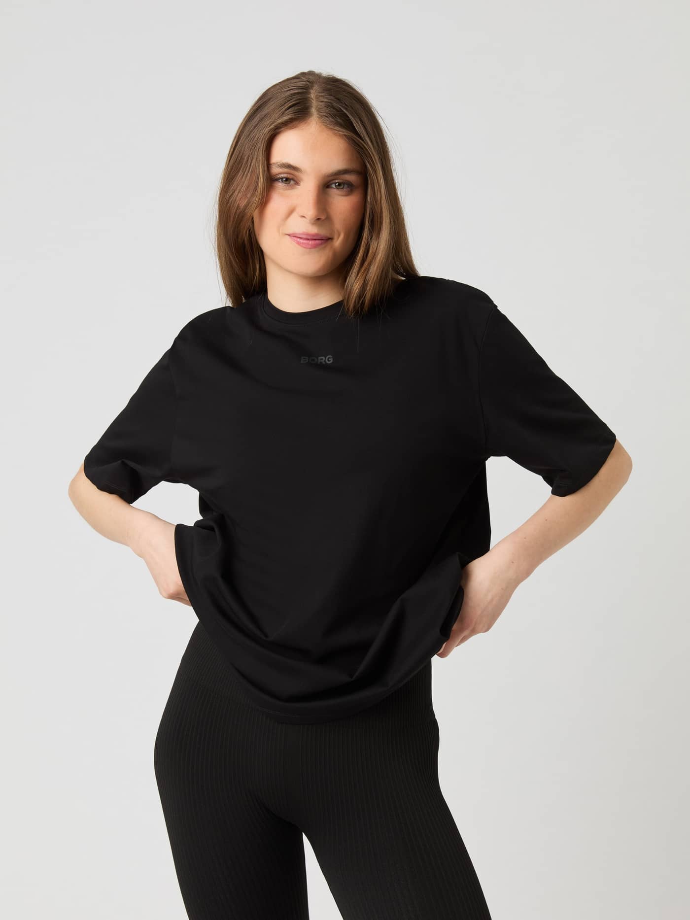 Front view of a woman wearing the Björn Borg Studio Oversized T-Shirt in black. - Image 1