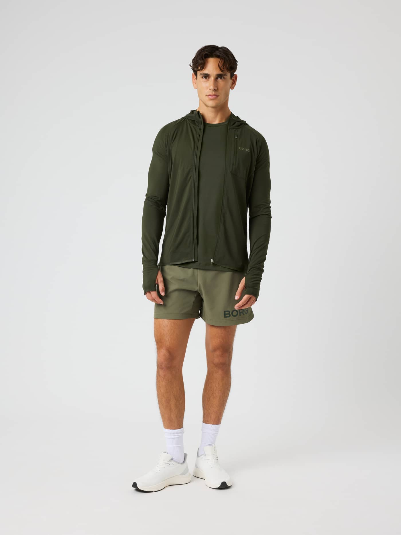 Full-body front view of the Borg Performance Mid Layer Hood in Rosin (Green) with a reflective logo for running. - Image 3