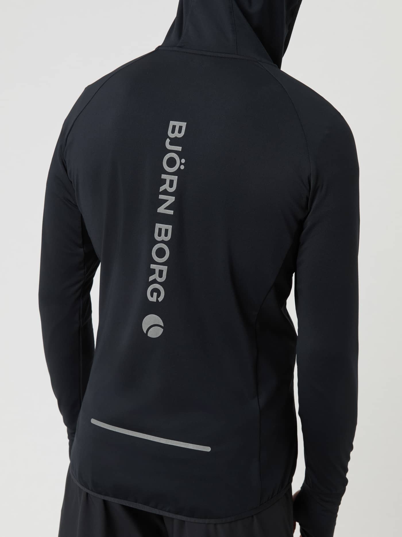Back view of a man wearing the Borg Running Mid Layer Hood in Black Beauty (Black) with a reflective logo. - Image 5