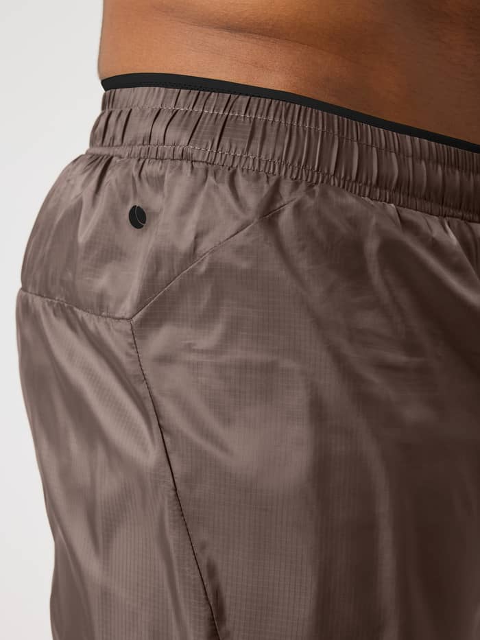 Zijaanzicht van de Borg Performance Shorts 2 In 1 in Falcon (Bruin) van geweven stof met zwart logo voor hardlopen. - Image 4