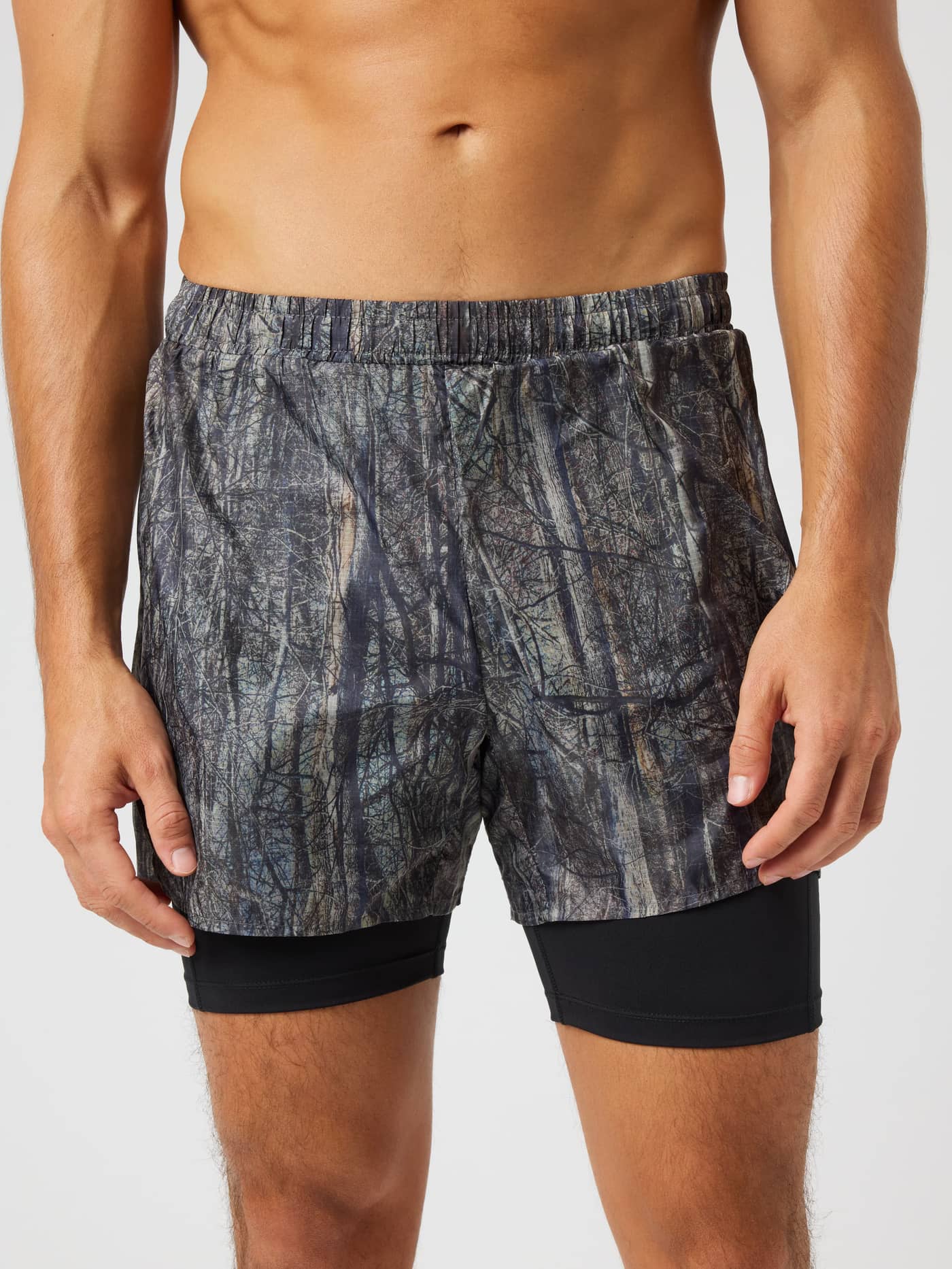 Front view of Borg Performance Shorts 2 In 1 in Forest 1 (Green) featuring a forest print and white logo for running. - Image 1