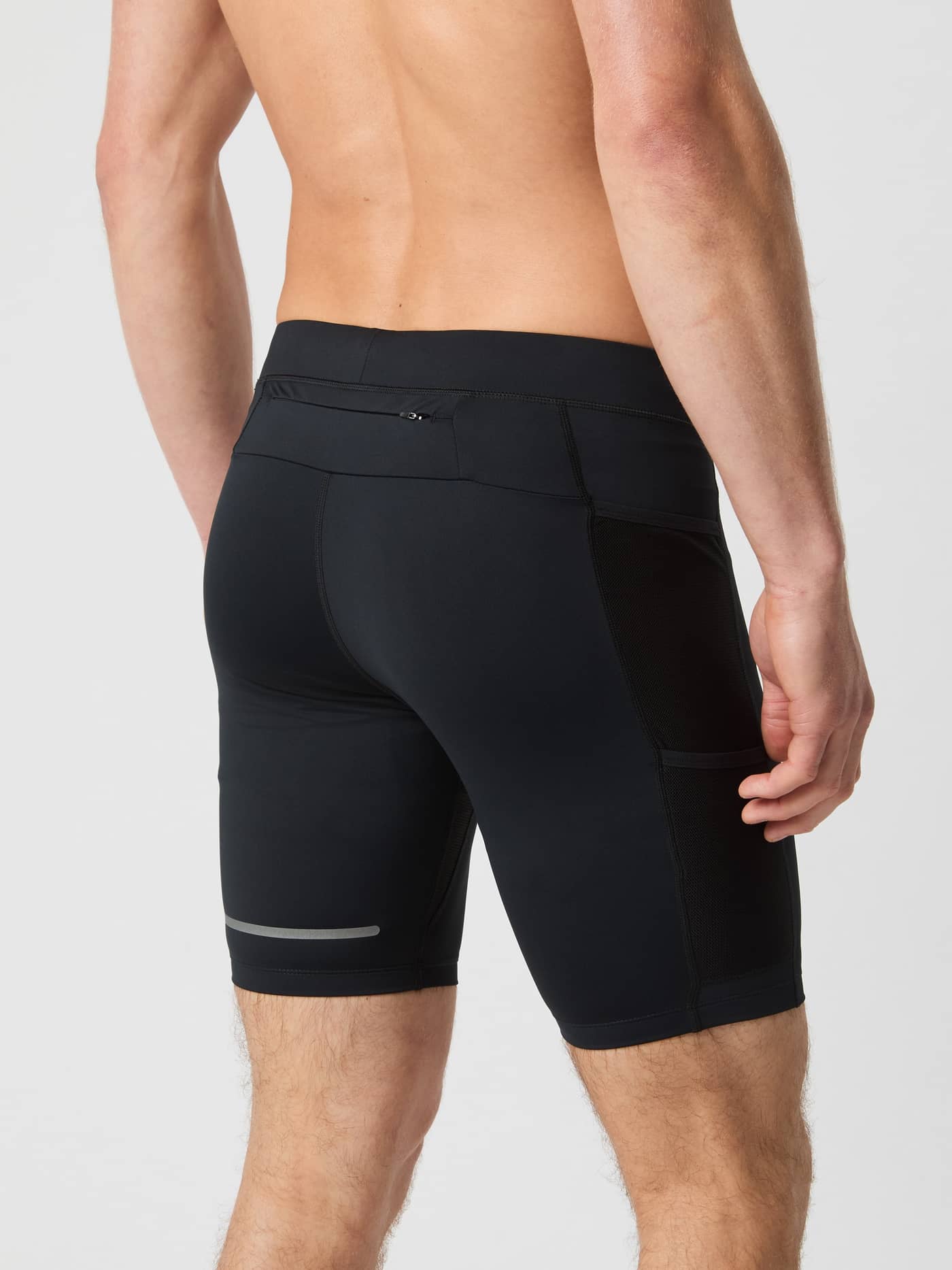 Achteraanzicht van een man in de Borg Running Short Tights in Black Beauty (Zwart) met mesh zakken en reflecterende details. - Image 2