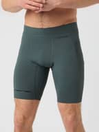 Front view of a man wearing the Borg Running Short Tights in Urban Chic (Green) with mesh pockets and a black logo.