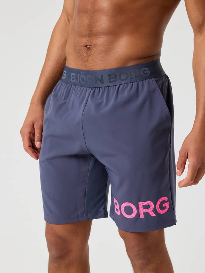 Front view of a man wearing the Odyssey Gray (Blue) Borg Shorts 9 Inch for training, combining style and function.