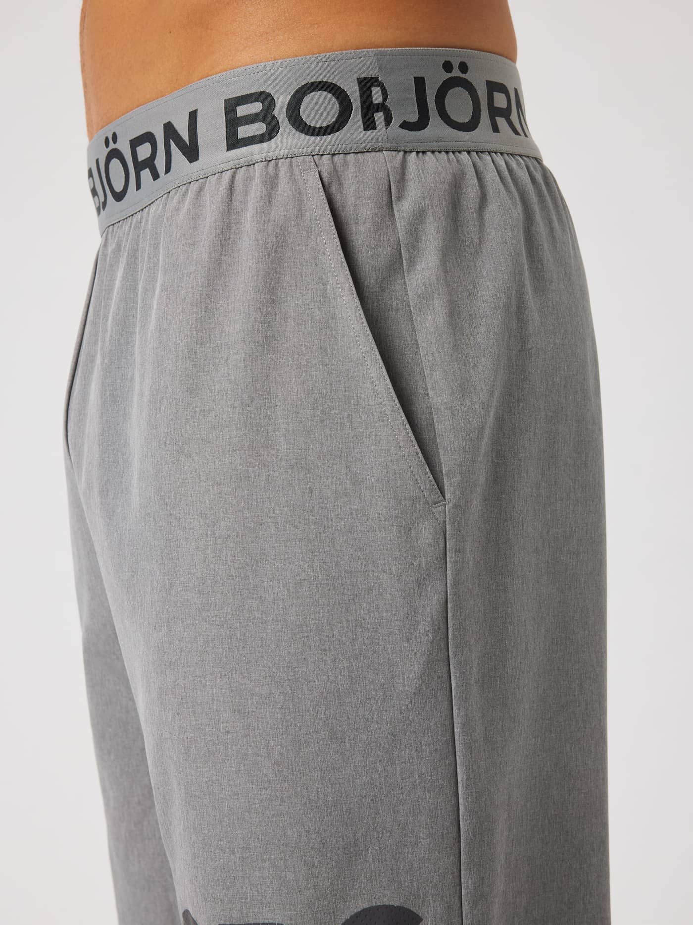 Close-up of the side pocket and elastic logo waistband on the Borg Shorts 9 Inch in Grey Melange (Grey) for training. - Image 5