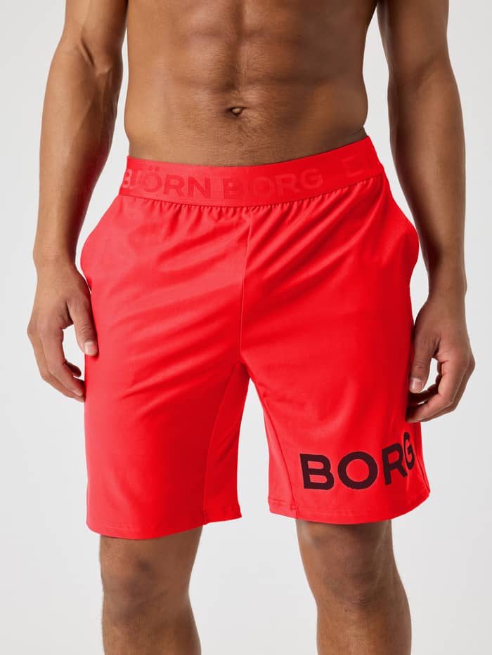 Borg Shorts 9 Inch i Flame Scarlet (Röd) sedda framifrån för träning med en svart logotyp och elastiskt logoband.