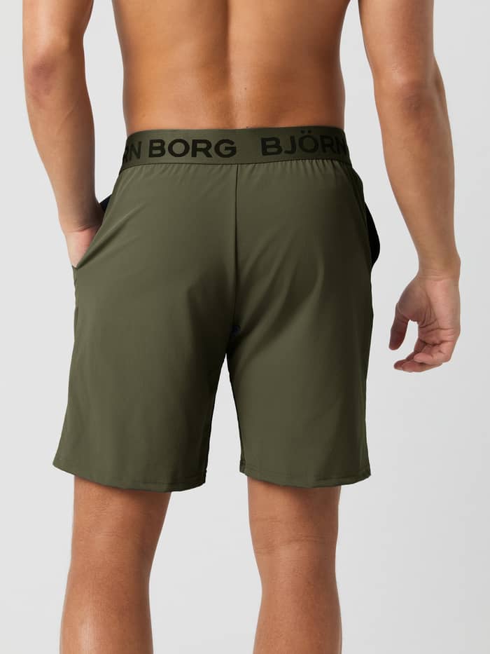 Back view of a model wearing the Borg Shorts in Forest Night, showing the black branded elastic waistband.
