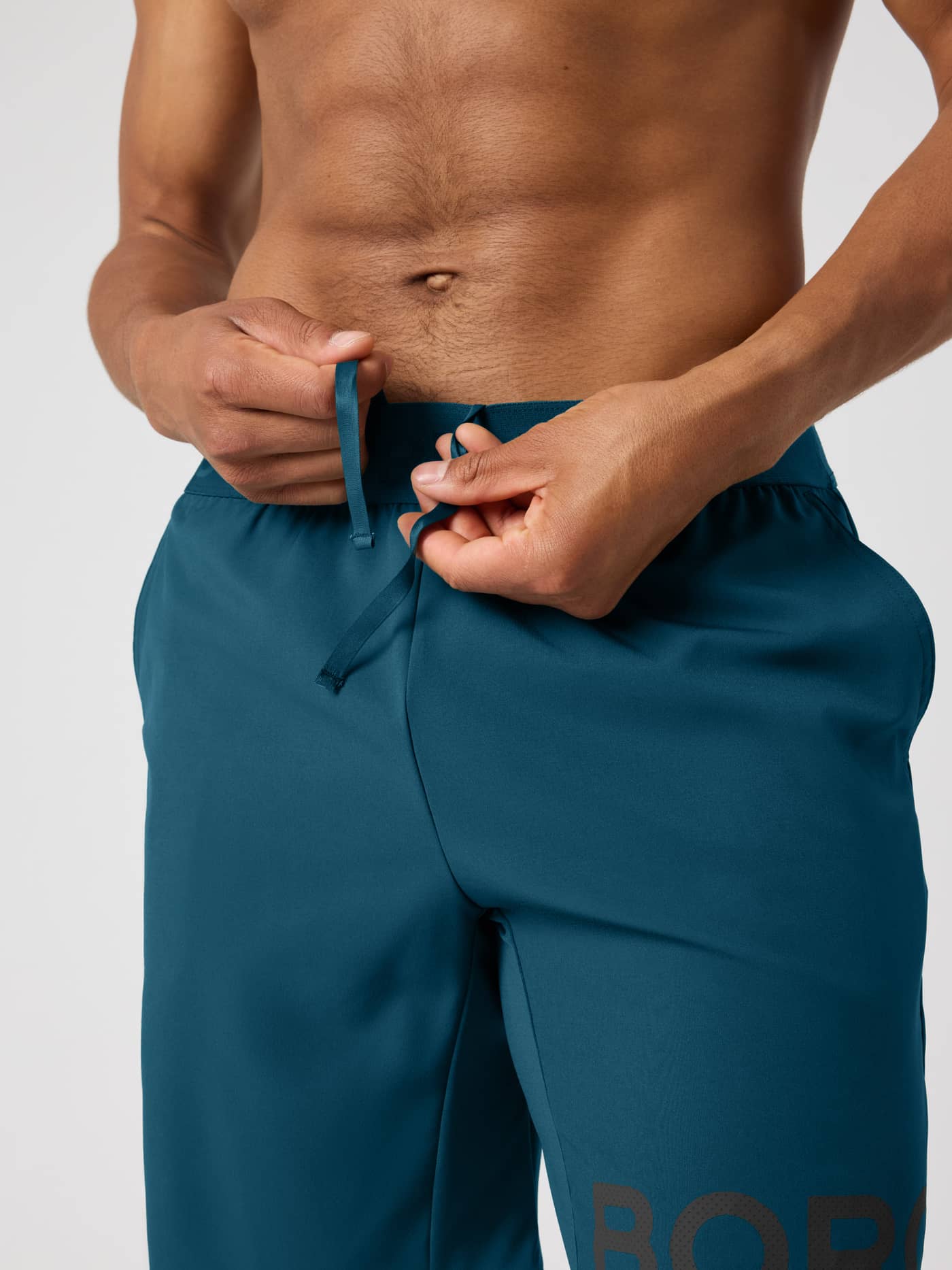 Adjustable drawstring detail on the Borg Shorts 9 Inch in Reflecting Pond (Green) for a custom fit during training. - Image 3