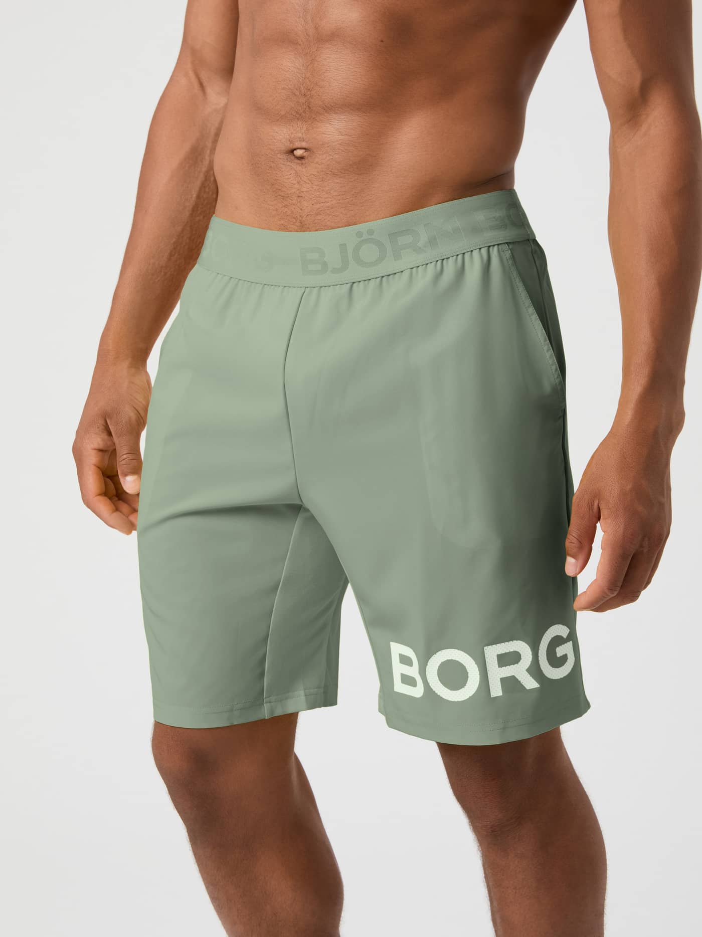 Front view of a model wearing the agave green Björn Borg Borg 9-inch Shorts. - Image 1