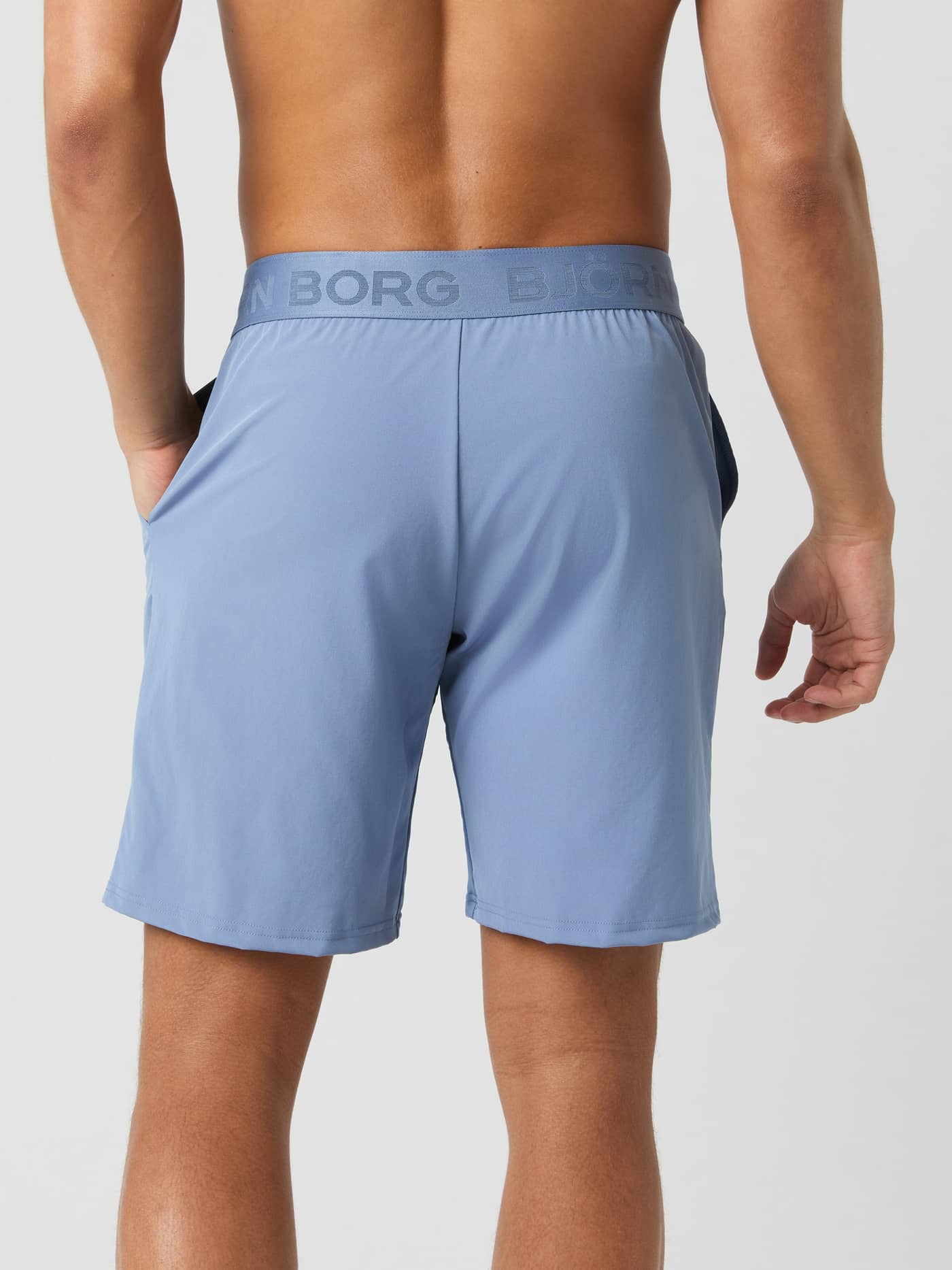 Back view of a man wearing the Björn Borg Borg 9" Shorts in stonewash. - Image 3