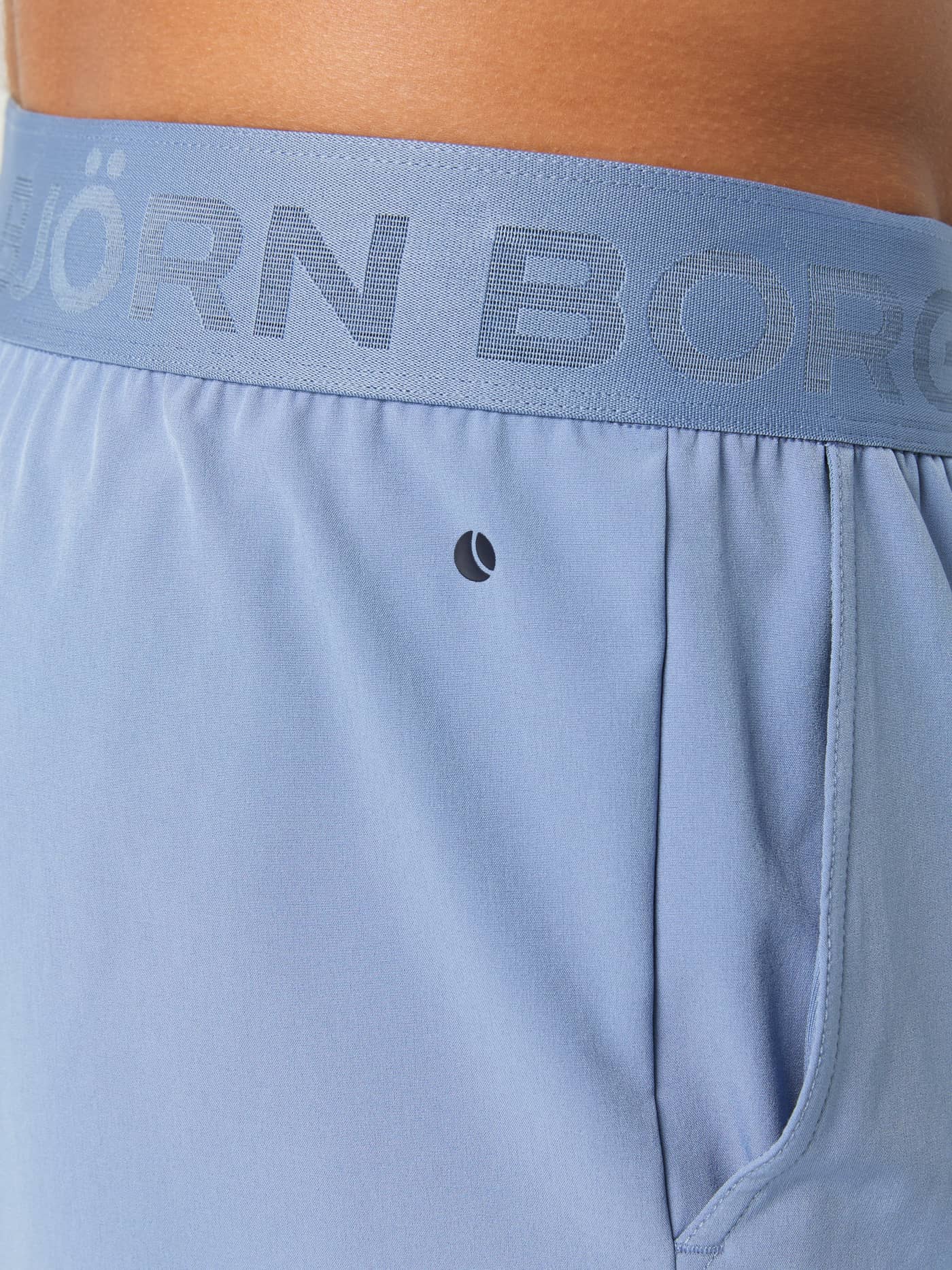 Close-up of the logo-branded elastic waistband on the men's Borg 9" Shorts in Stonewash. - Image 6