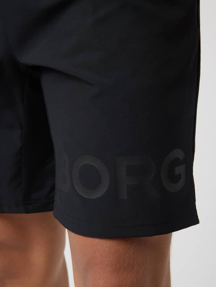 Gros plan du logo perforé sur la jambe du Borg Shorts 9 Inch en Black Tonal Logo (Noir) pour le tennis et l'entraînement. - Image 5