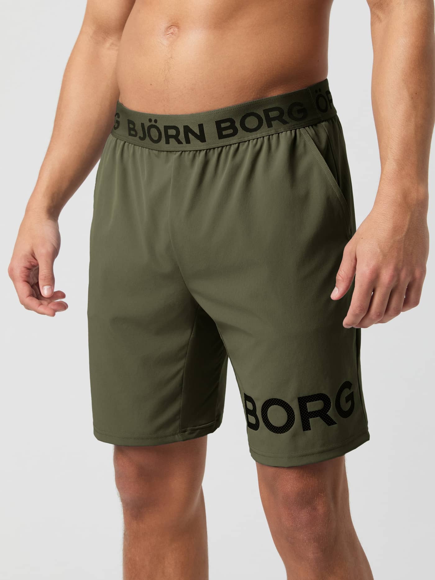 Front view of a man wearing the Björn Borg Borg 9" Shorts in Forest Night. - Image 1
