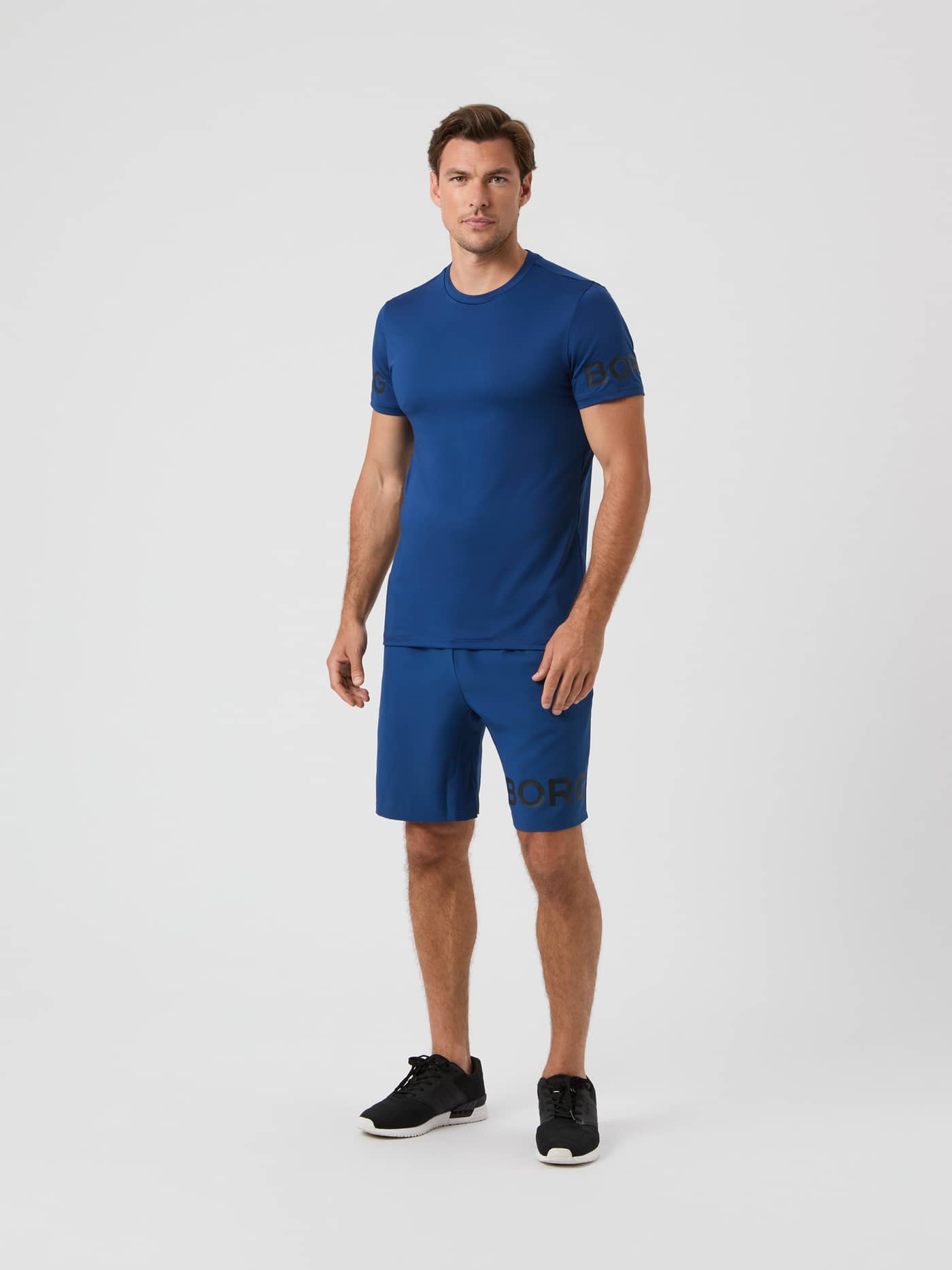 Full-body view of a model wearing the Björn Borg Borg 9-inch Shorts in Estate Blue with a matching t-shirt. - Image 3