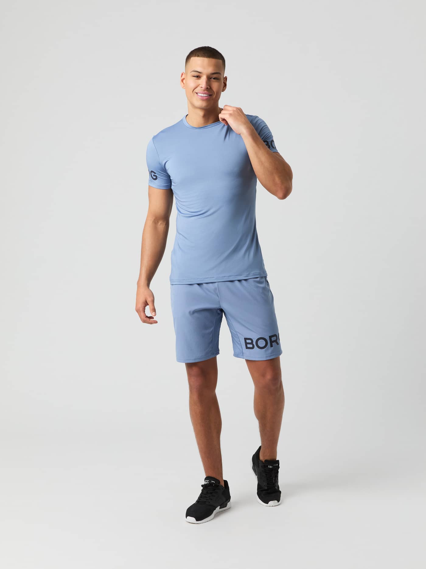 Model from the front wearing the Björn Borg Borg 9-inch Shorts in stonewash blue with a matching t-shirt. - Image 2