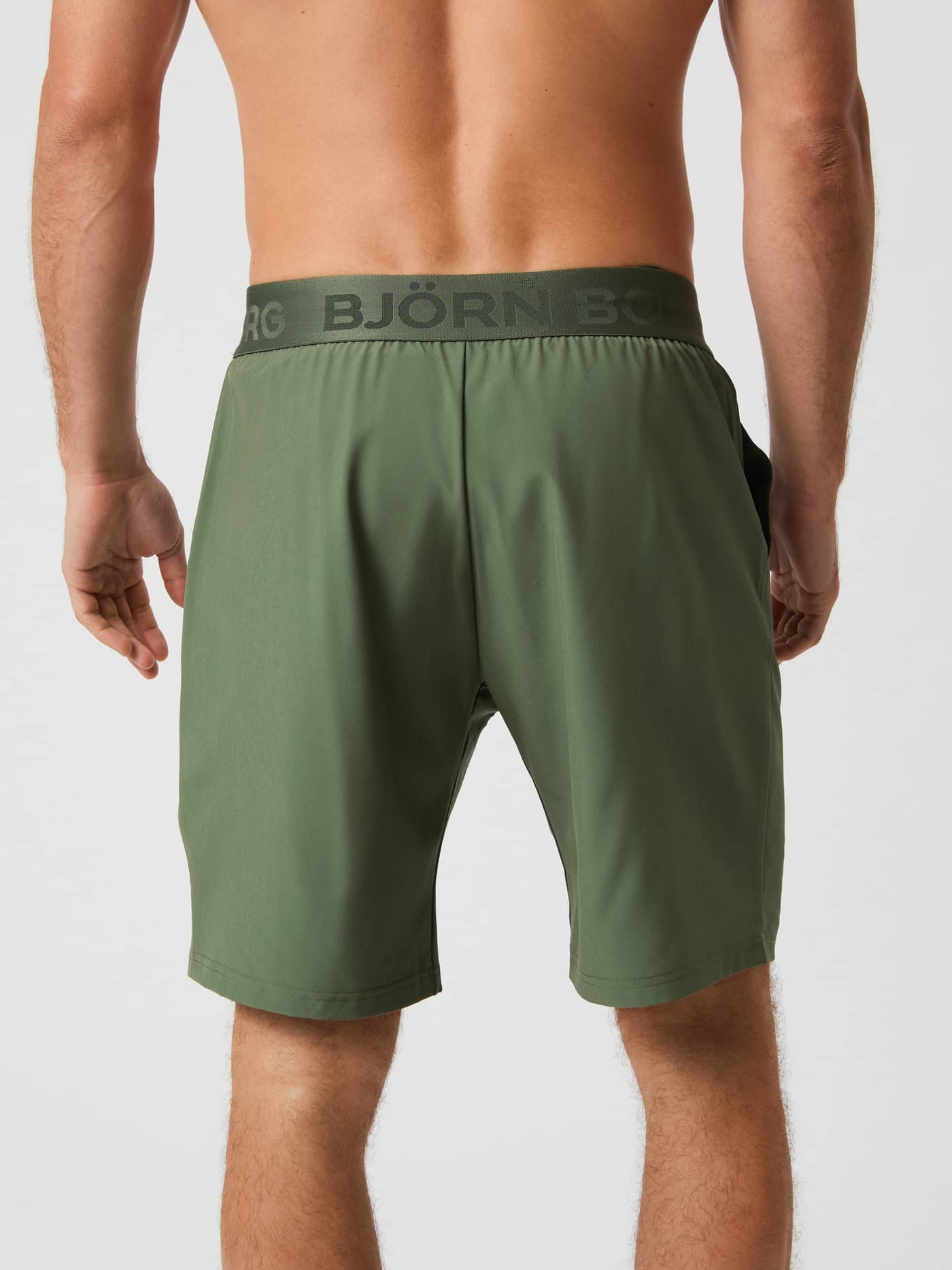 Back view of a model wearing the Björn Borg Borg 9" Shorts in thyme green. - Image 2