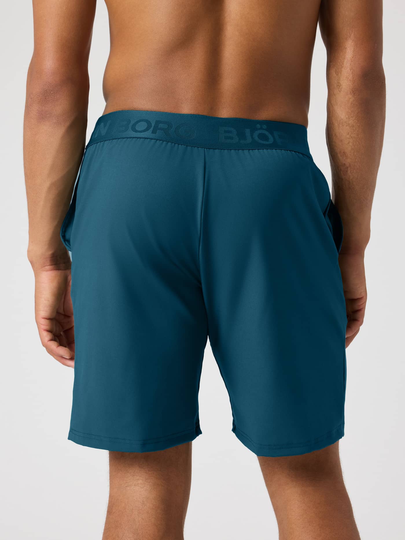 Back view of Borg Shorts 9 Inch in Reflecting Pond (Green) for training, featuring a tonal branded elastic waistband. - Image 2