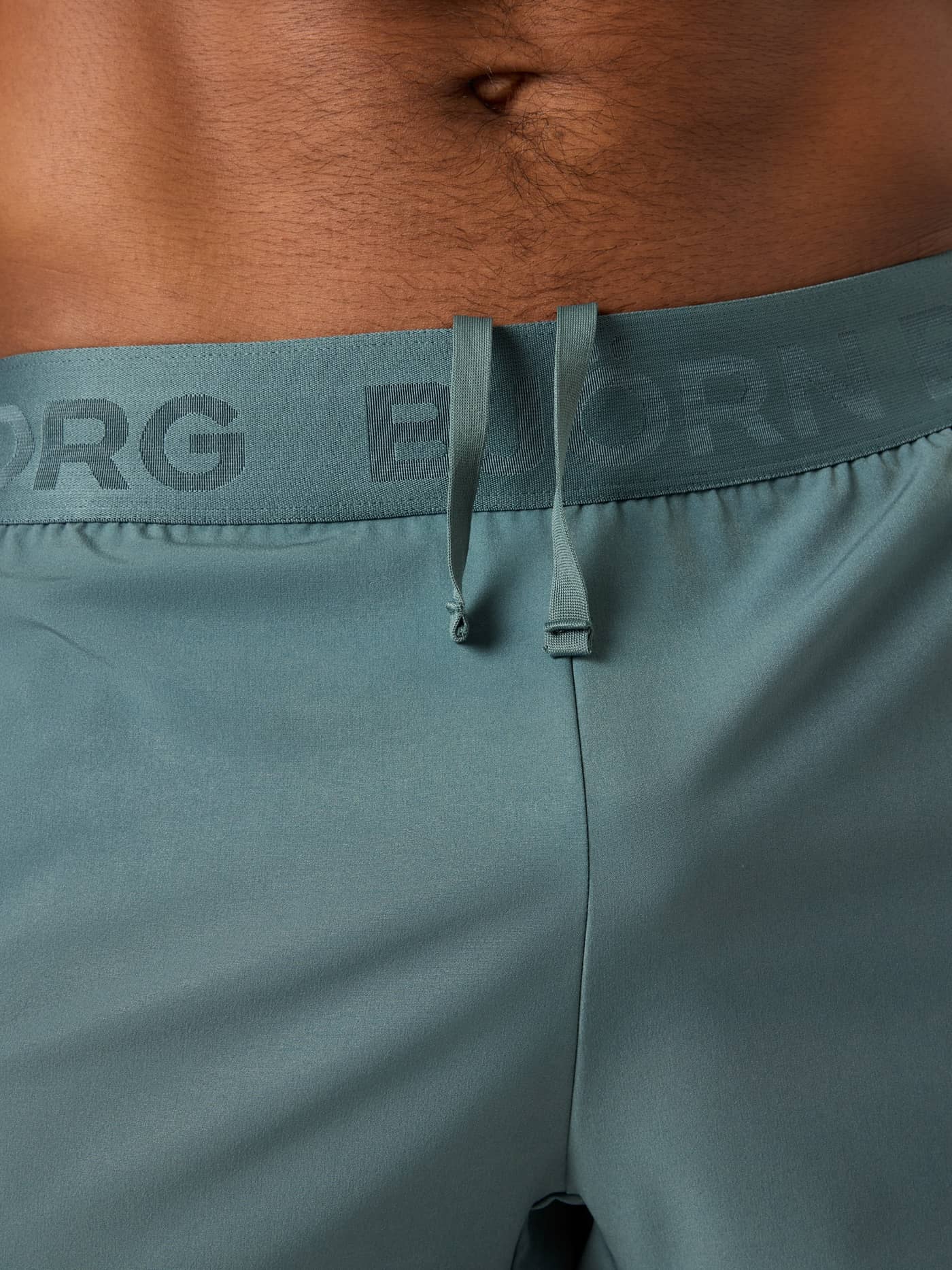 Close-up of the branded waistband and drawstring on the training Borg Shorts 6 Inch in Balsam Green (Green). - Image 6