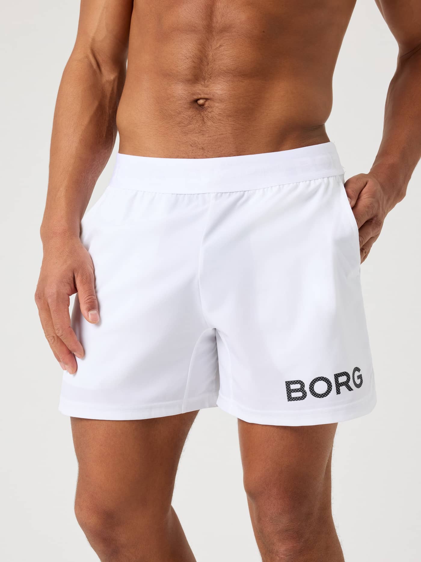 Front close-up of a man wearing the brilliant white Björn Borg Borg 6-inch Shorts. - Image 1