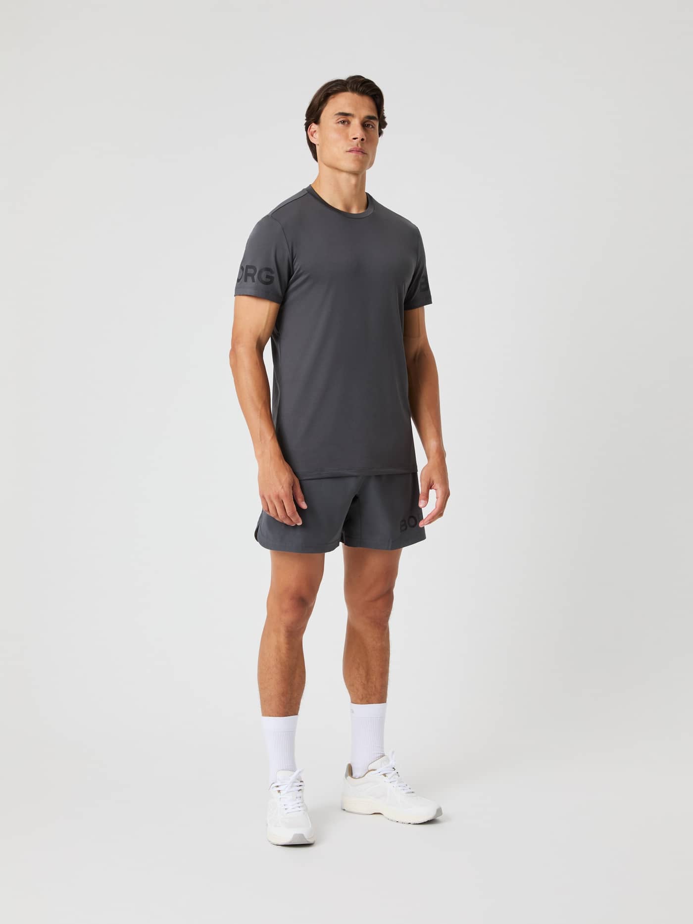 Front view of a model wearing the Borg 6-inch Shorts in asphalt grey with a matching t-shirt. - Image 2
