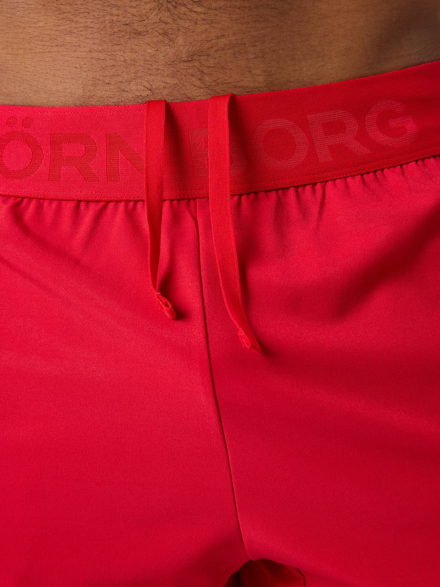 Close-up of the tonal branded waistband and drawstring on the training Lychee (Red) Borg Shorts 6 Inch. - Image 6