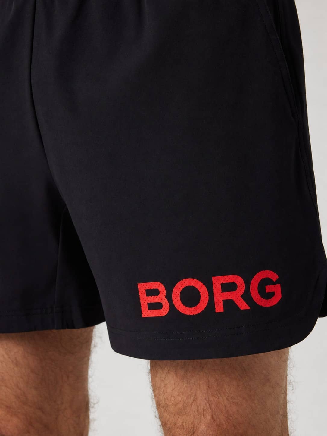 Close-up of the Borg Shorts 6 Inch in Black Red Logo (Black) featuring a large red logo for functional training. - Image 3
