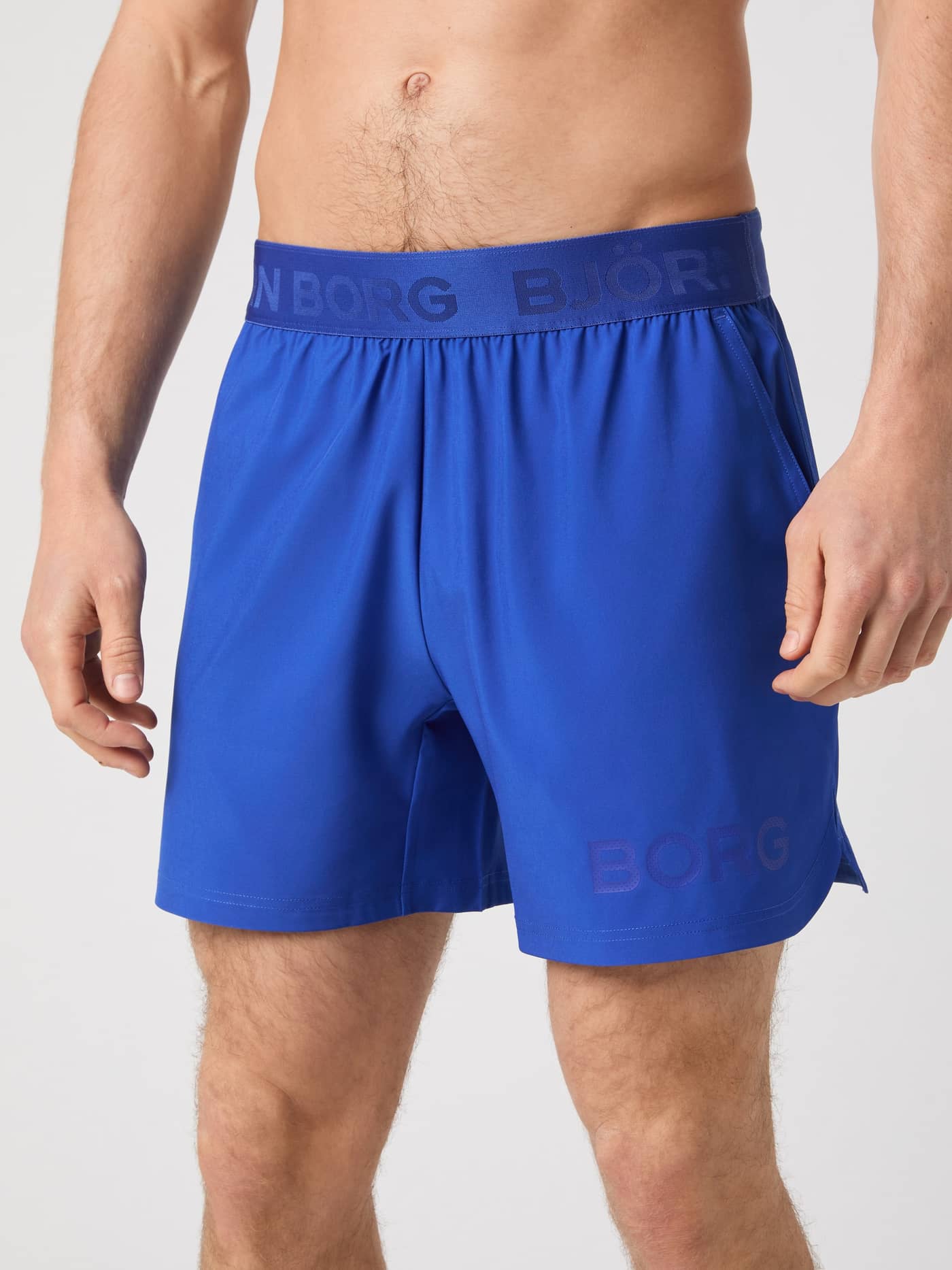 Närbild framifrån på Björn Borg Shorts 6 Inch i Surf The Web (Blå) för träning med fokus på den logomärkta midjeresåren. - Image 1