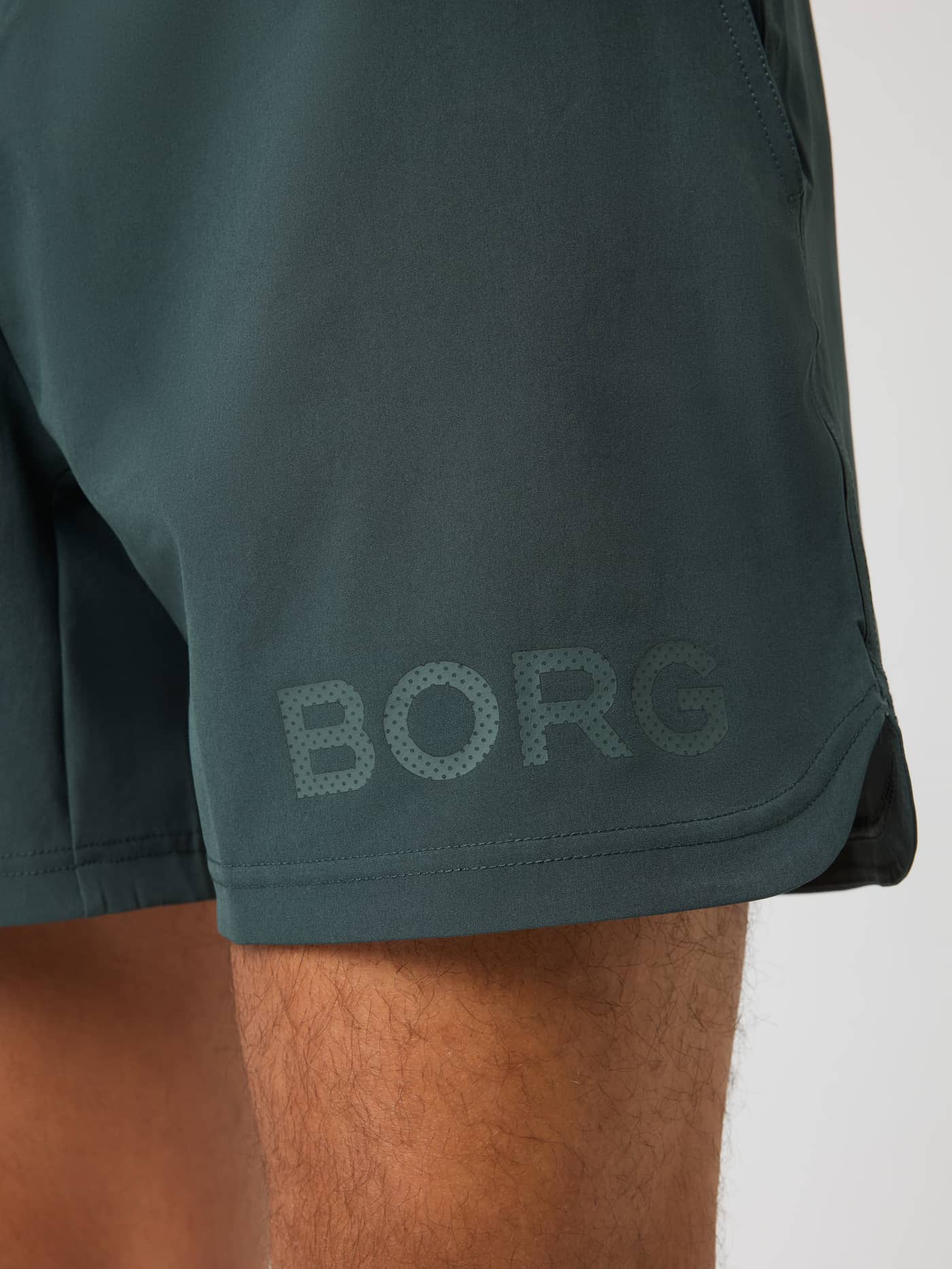 Detailed close-up of the tonal BORG logo on the Urban Chic (Green) Borg Shorts 6 Inch training shorts. - Image 3