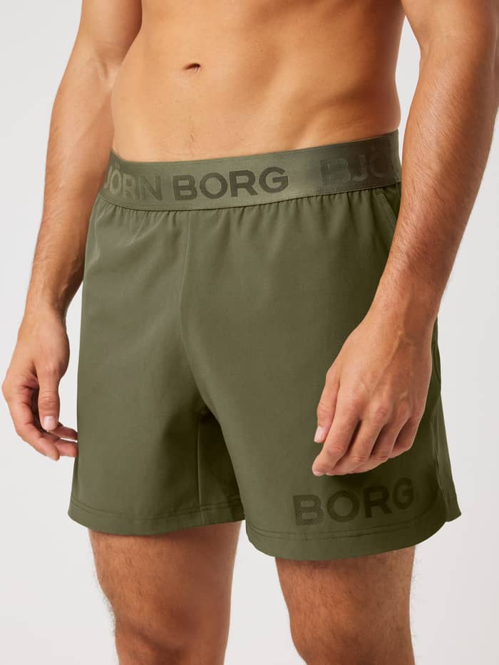 Vue de face du Borg Shorts 6 Inch en Kalamata (Vert) pour le training avec ceinture griffée et fentes latérales.