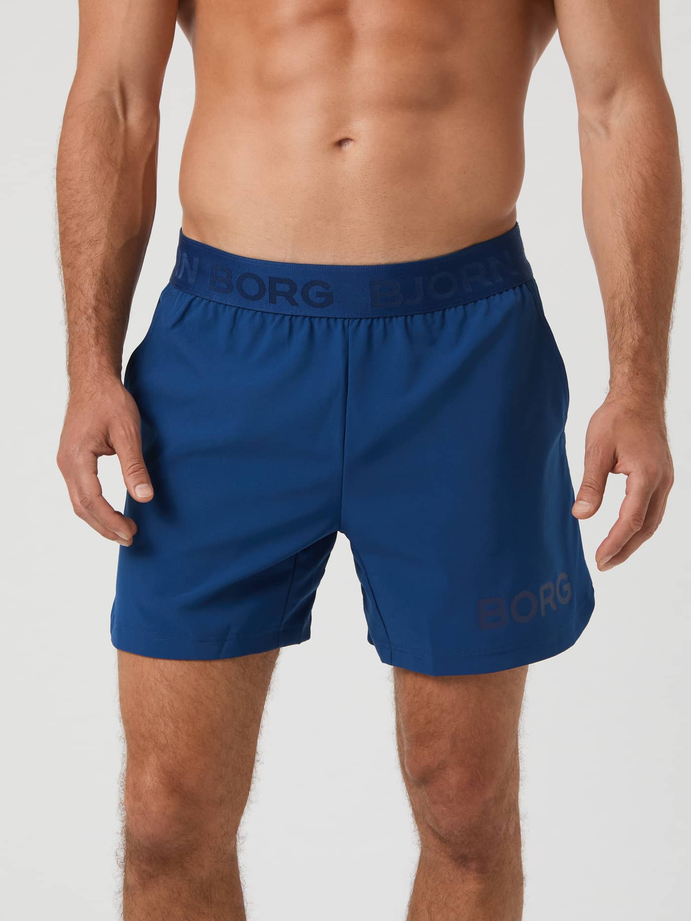 Front view of a model wearing the Björn Borg Borg 6" Shorts in Estate Blue. - Image 1