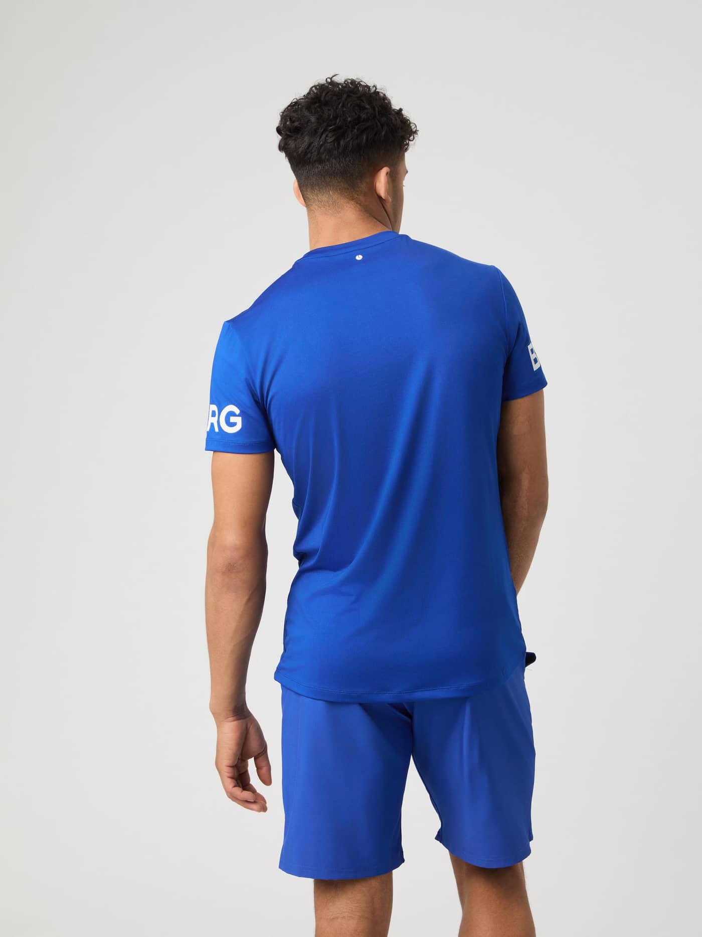 Back view of a model wearing the Borg T-Shirt in Surf The Web blue. - Image 2