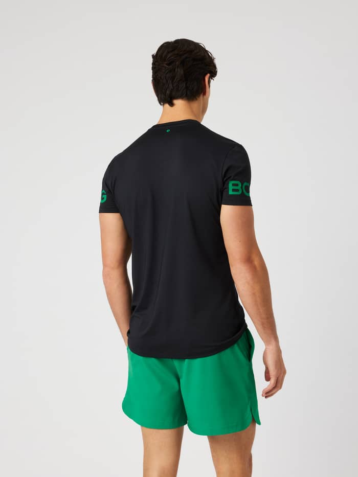 Back view of the Borg T-Shirt in Black Beauty (black) with green logo prints on the arms for training.
