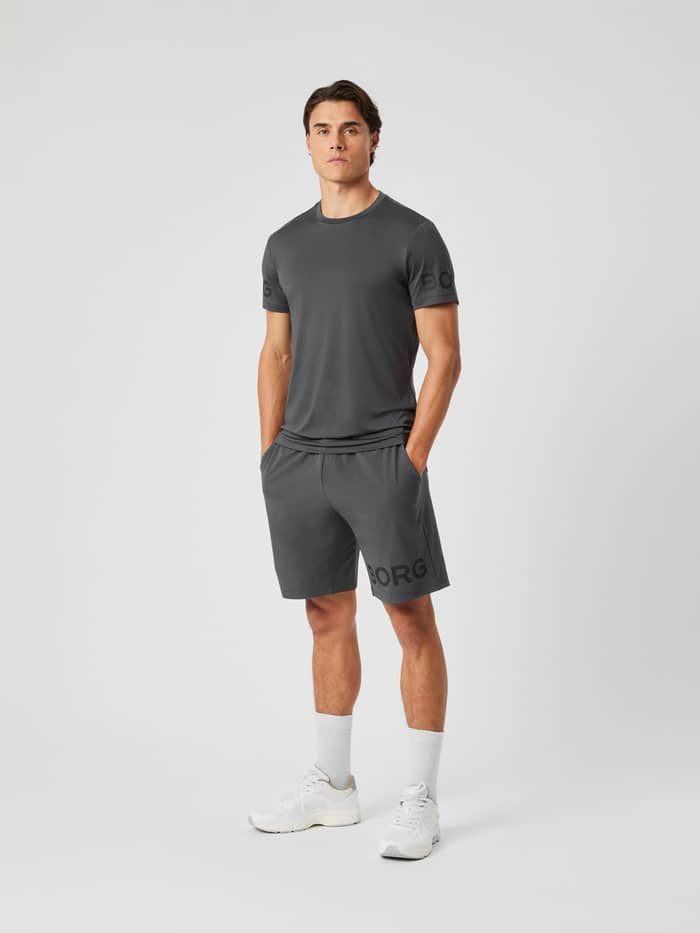 Full-length view of a man wearing the asphalt grey Borg T-shirt and matching shorts against a light grey background. - Image 3