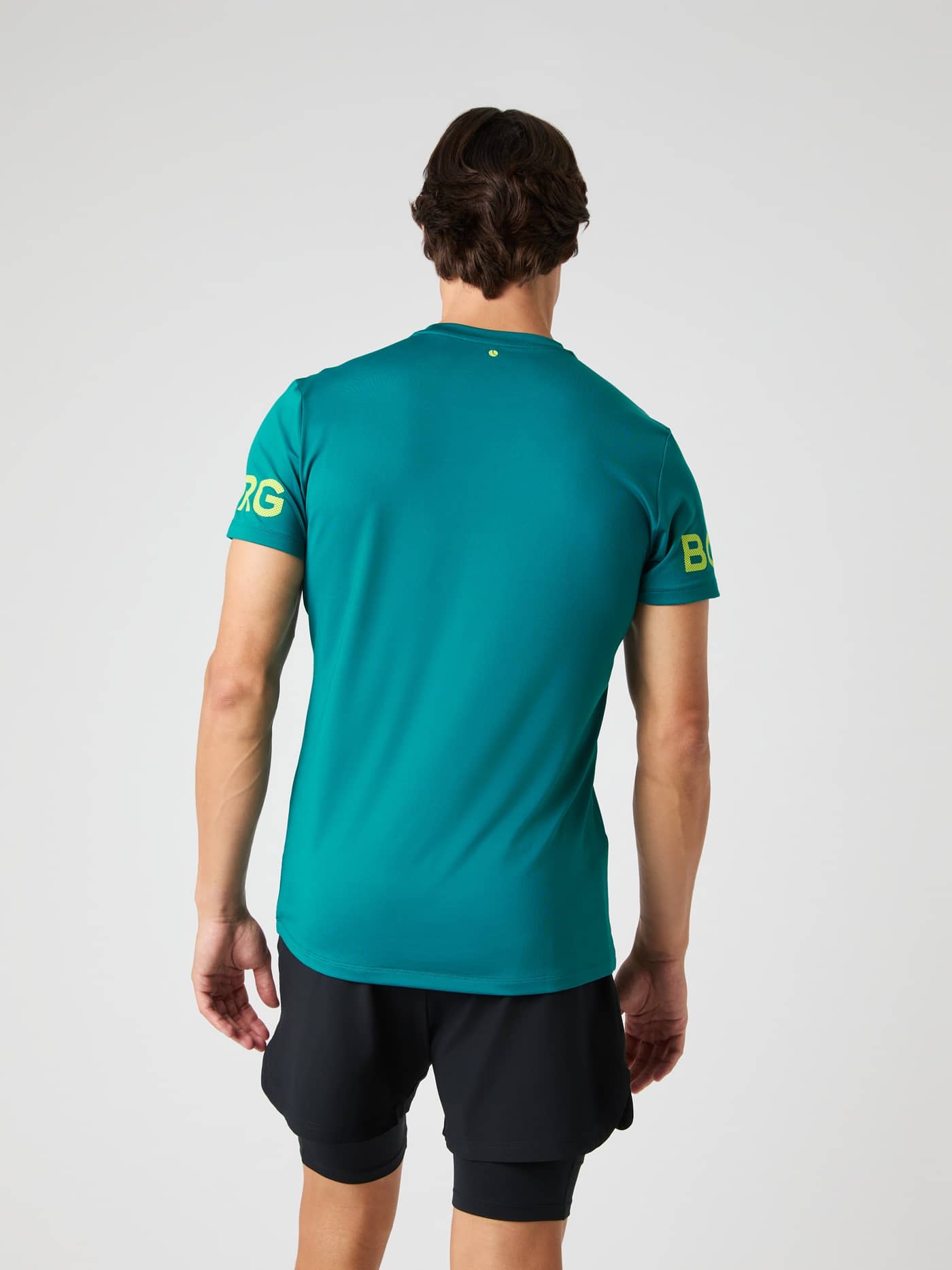 Back view of a model wearing the Borg T-shirt in Shaded Spruce. - Image 5