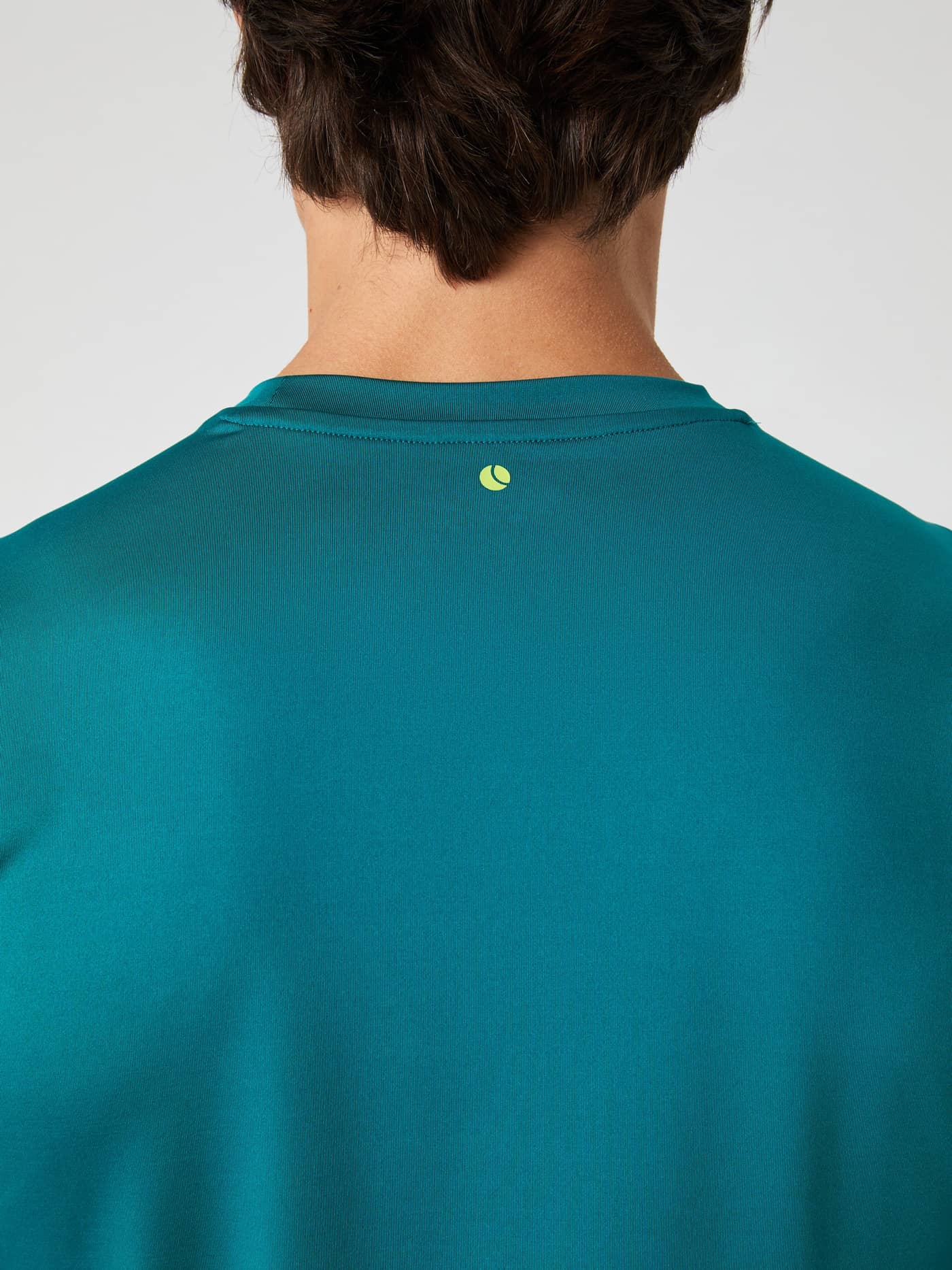 Close-up of the back of the Borg T-Shirt in Shaded Spruce, highlighting the small logo below the neckline. - Image 7