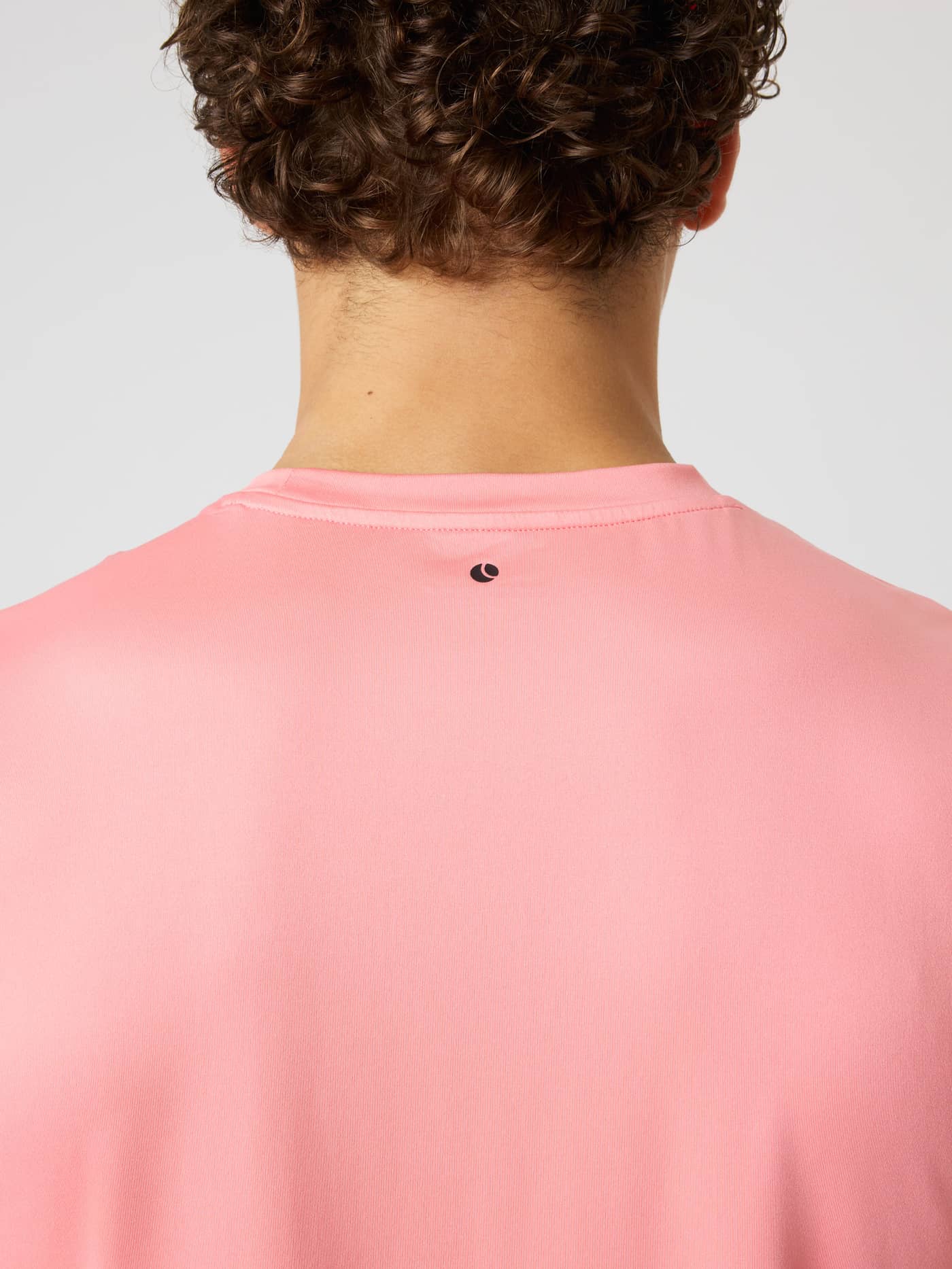 Back view of the Borg T-shirt in Strawberry Ice (Pink) showing a black tennis ball logo for training and tennis. - Image 5