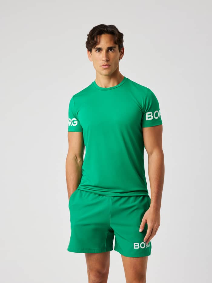 Male model wearing the Borg T-Shirt in Jolly Green (green) with white logo print for training.