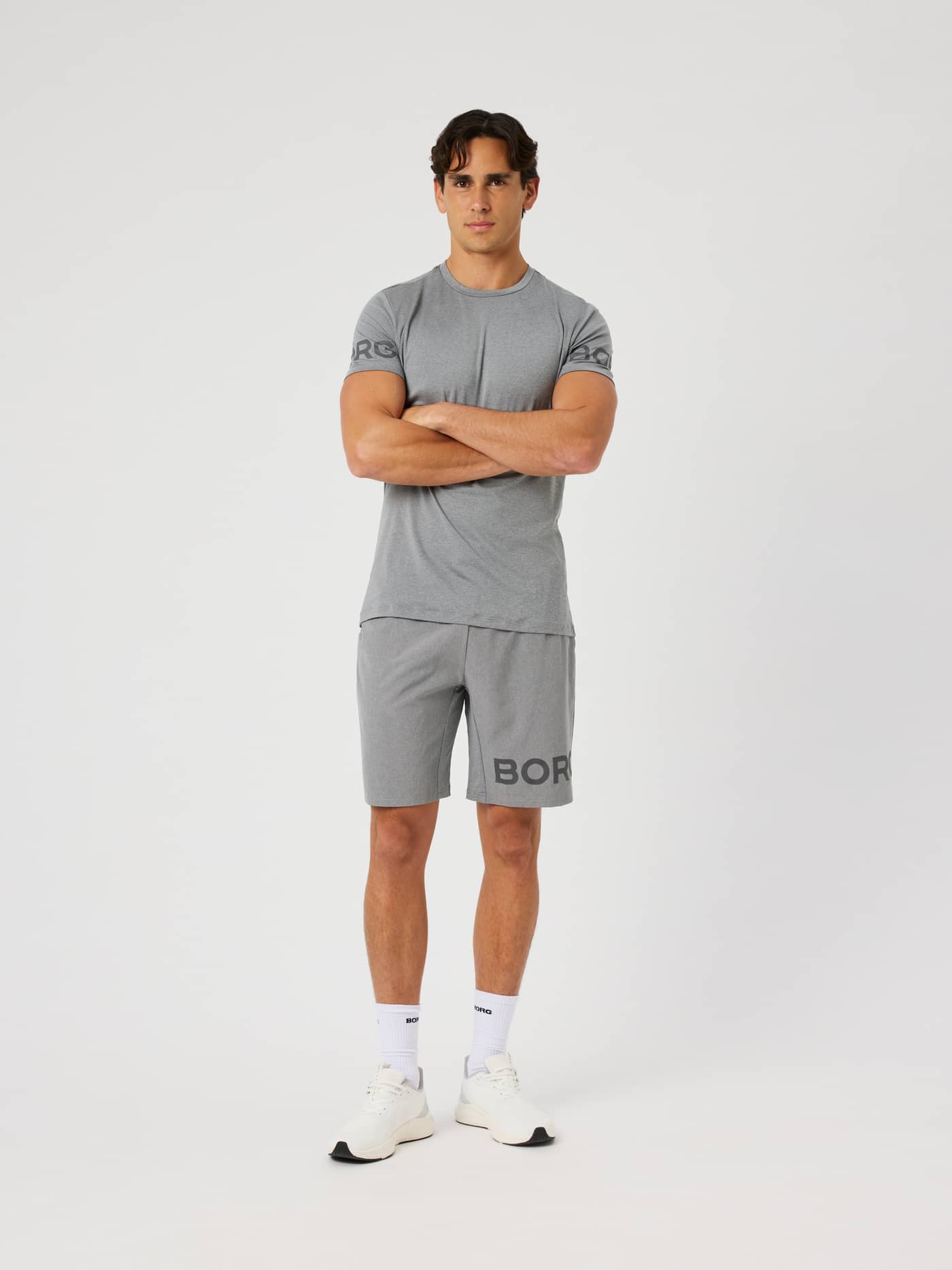 Male model wearing the Borg T-Shirt in grey melange (Grey) with the iconic Borg logo on the arms for training. - Image 4