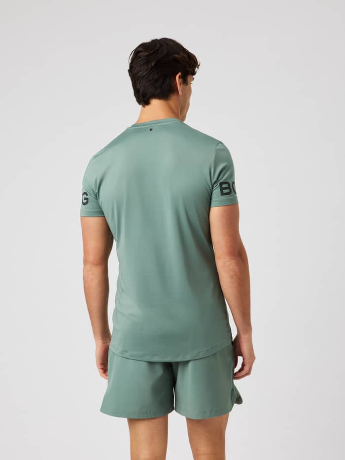 Back view of the Borg T-Shirt in Laurel Wreath (Green) showcasing the longer back coverage and training logo print.
