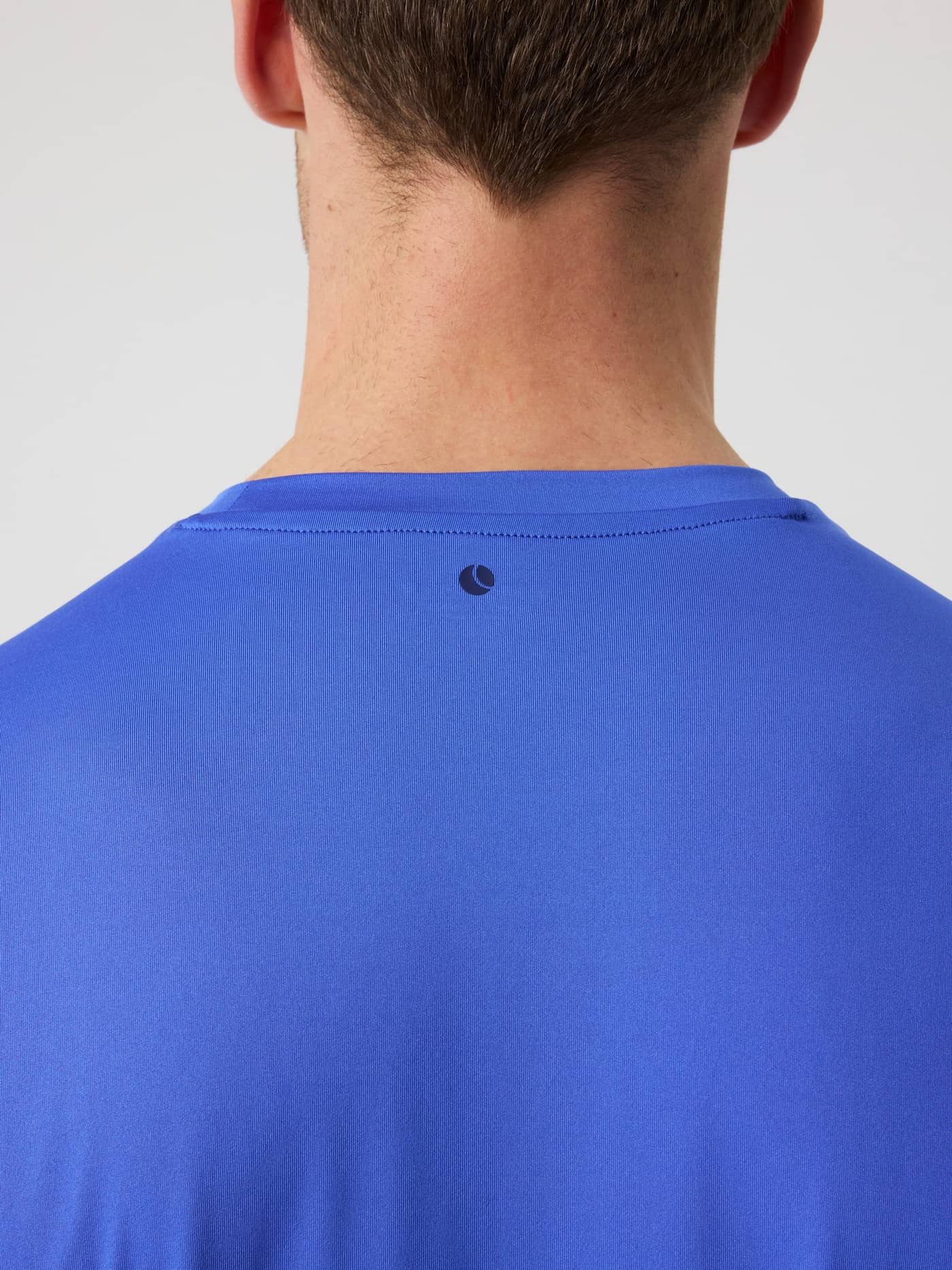 Borg T-Shirt i Amparo Blue (Blå) set bagfra i nærbillede med et mørkt tennisbold-print til træning og tennis. - Image 5