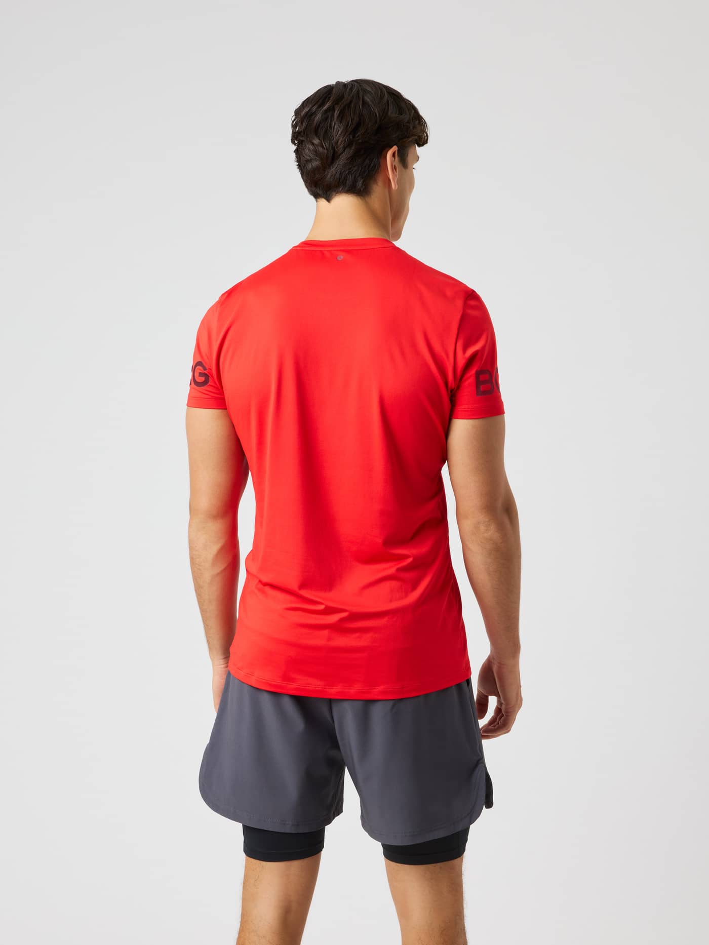 Borg T-Shirt in Flame Scarlet (Red) seen from the back, designed for training and tennis with black sleeve logos. - Image 3