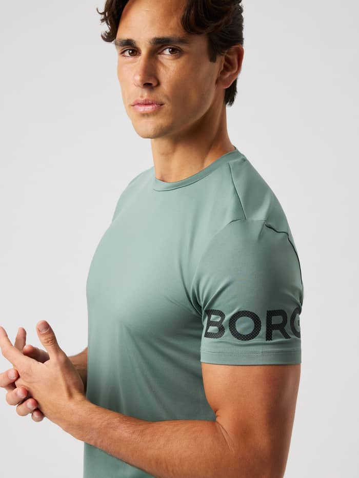 Close-up of the Borg T-Shirt in Laurel Wreath (green) highlighting the black Borg logo on the sleeve for training.