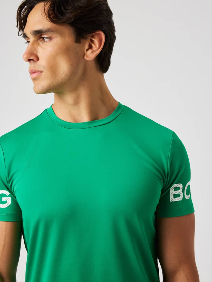 Close-up of the Borg T-Shirt in Jolly Green (green) highlighting the round neck and white logo on the arm for training.