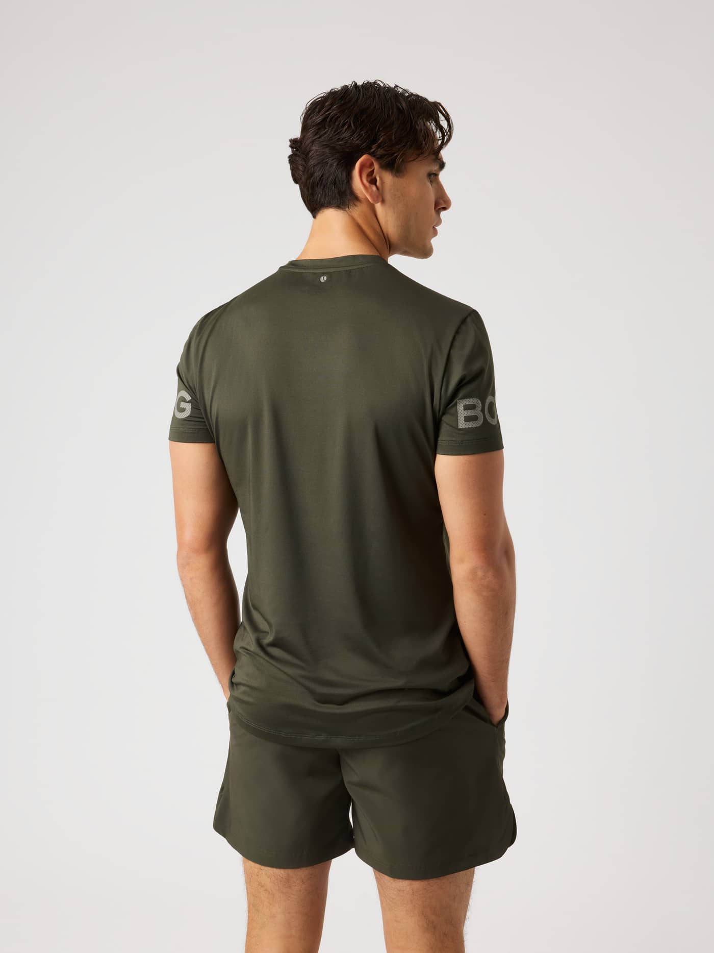 Back view of the Borg T-Shirt in Rosin (Green) featuring perforated sleeve logos for training and tennis. - Image 3