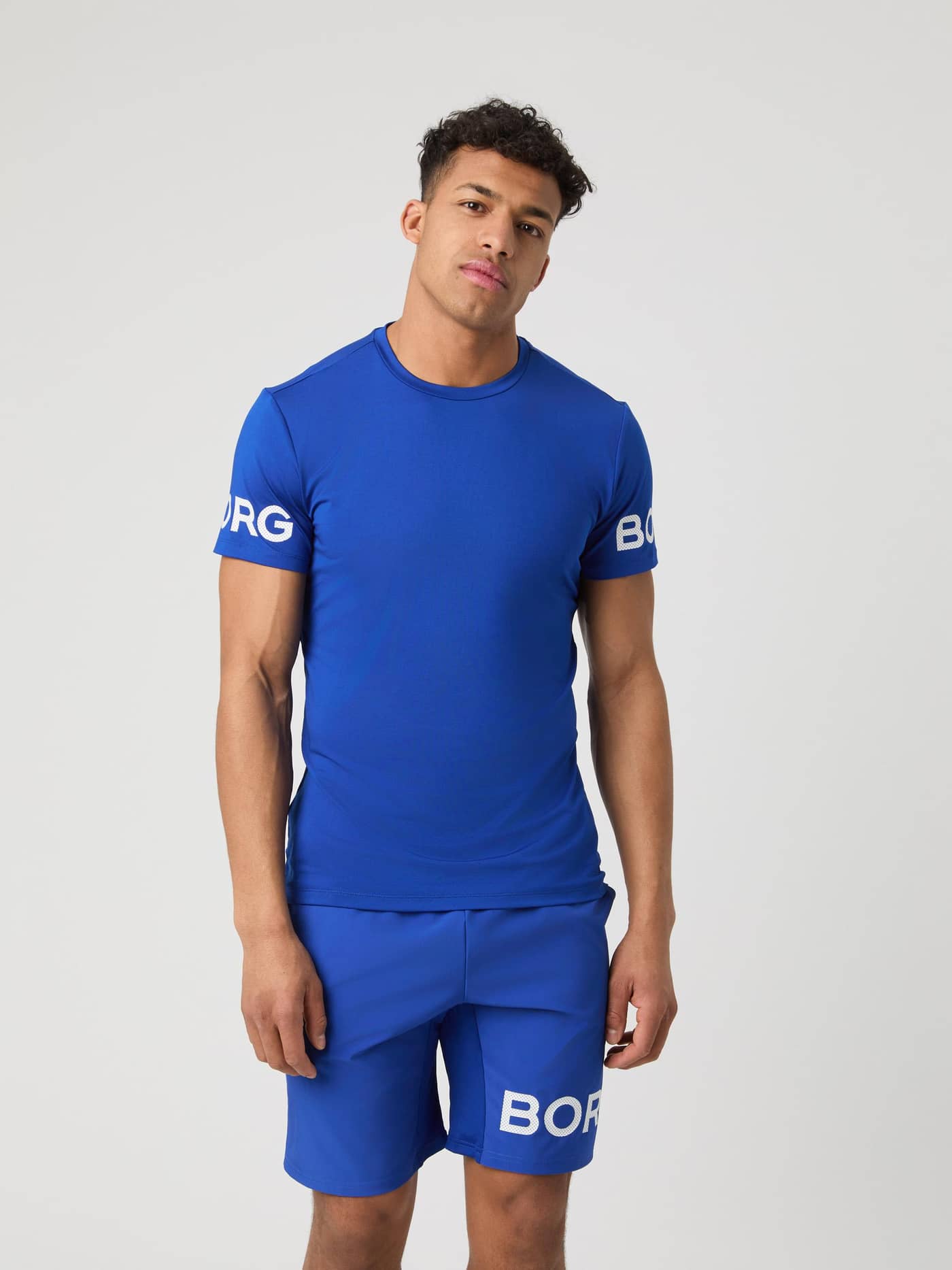 Front view of a model wearing the blue Borg T-shirt and matching blue shorts. - Image 1